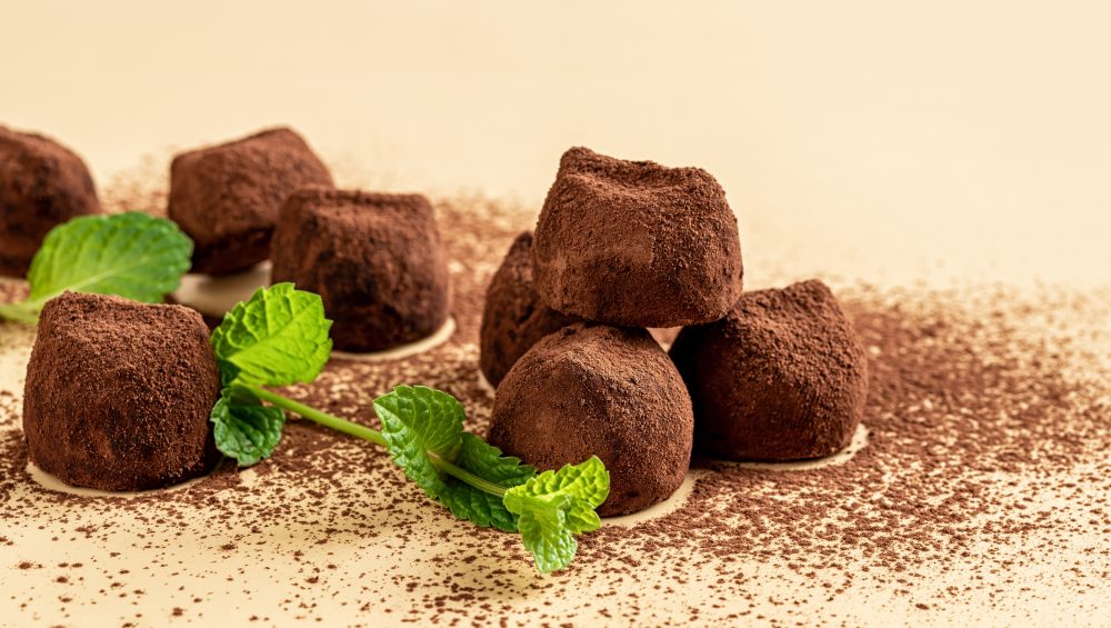 Chocolate,Truffles,And,Fresh,Mint,Over,Beige,Background.,Dark,Chocolate